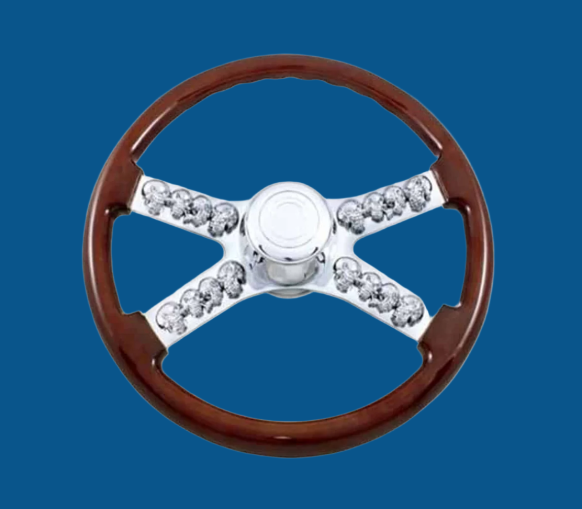 A Wood and Chrome Steering Wheel with Skulls in the middle